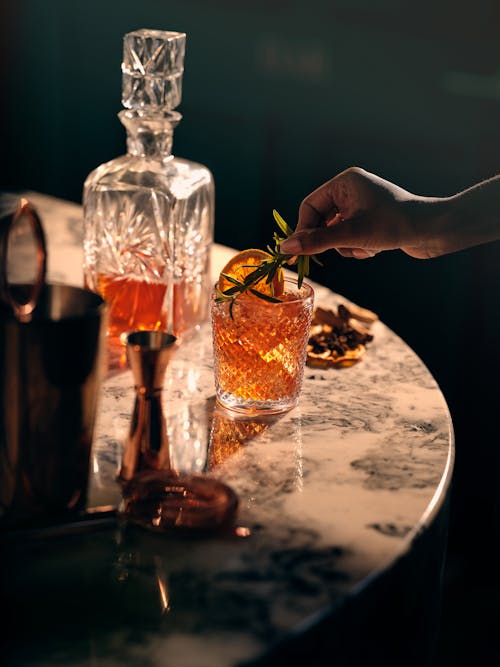 Woman Hand over Glass of Alcohol