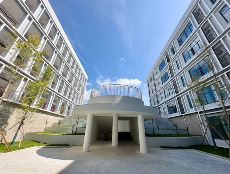 Contemporary apartment buildings with unique design against a clear blue sky.