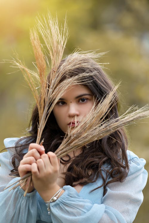 Brunette Woman Holding Plants