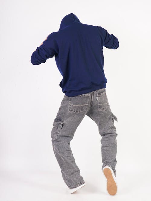 Model in a Navy Blue Hoodie and Faded Black Denim Cargo Pants from Behind