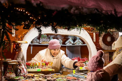 Elderly Woman Merchant at Christmas Market Stall