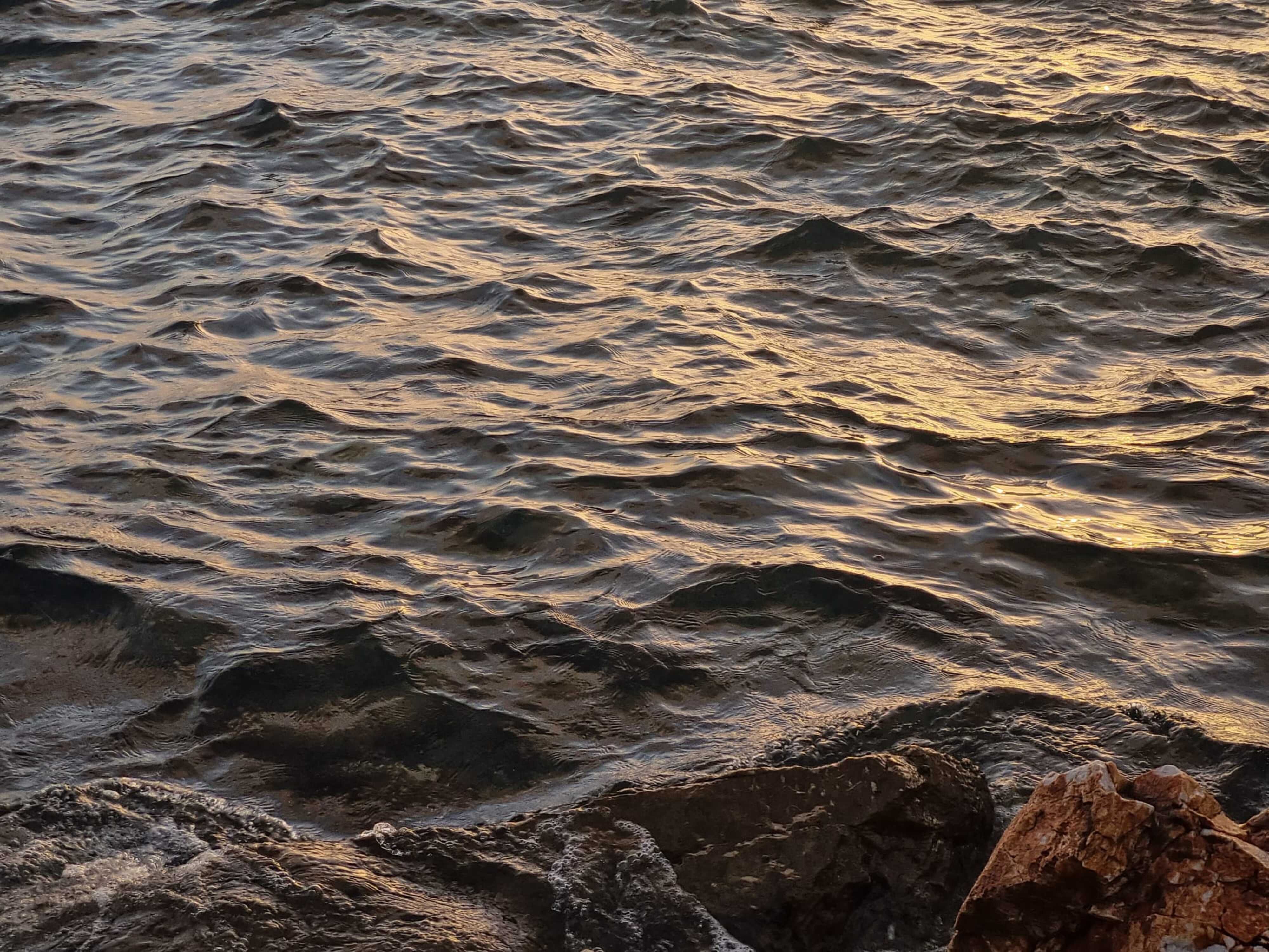 Rocks Sticking Out of the Rippling Ocean Water · Free Stock Photo
