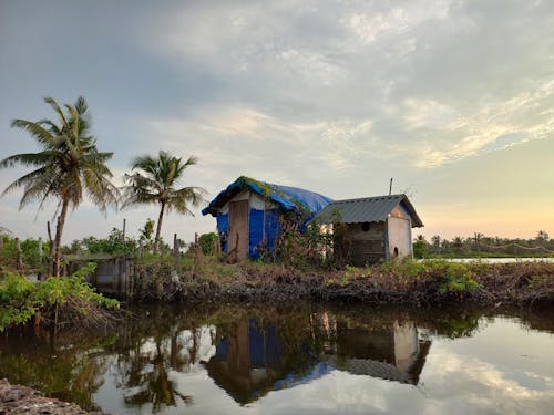 Simple Rustic Sheds on the Bank of a Tropical River