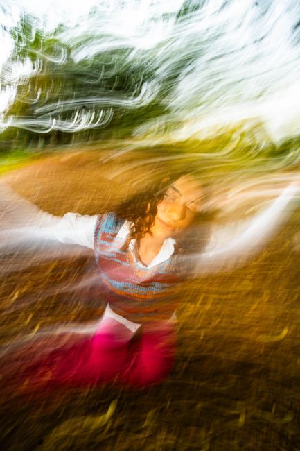 Abstract portrait with motion blur effect in a Lisbon park setting.
