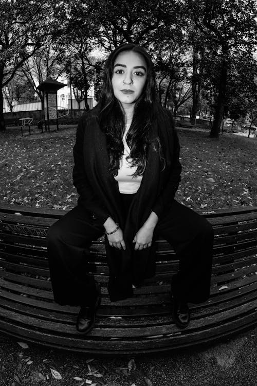 Brunette in Pants Sitting on Bench 