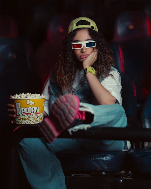 Woman in Cap Sitting at Cinema