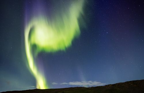 Free Stunning Aurora Borealis dances across the night sky over Iceland, creating a mesmerizing natural spectacle. Stock Photo