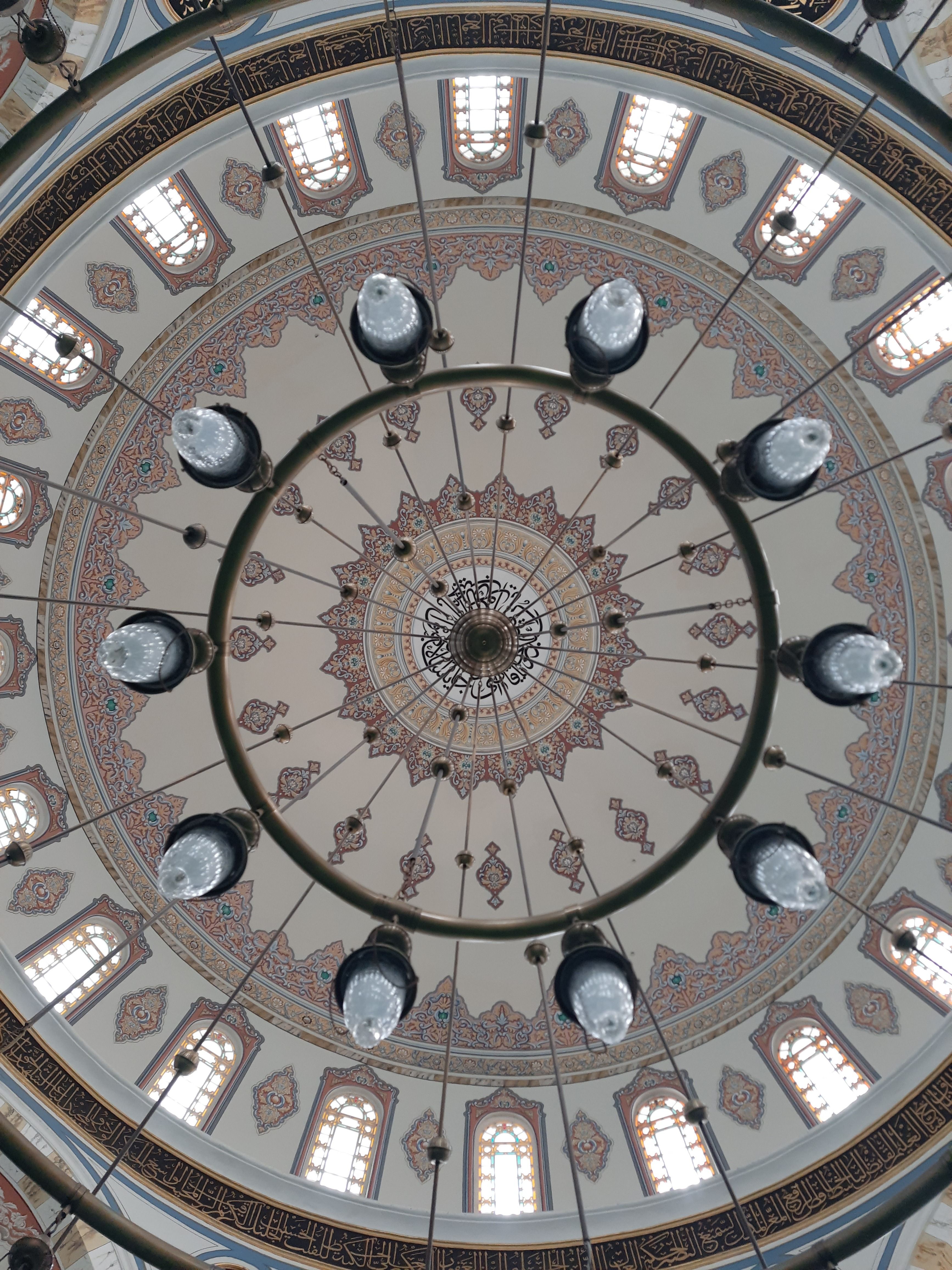 Ornate chandelier and decorated ceiling of Hamid-I-Evvel Mosque in Istanbul.