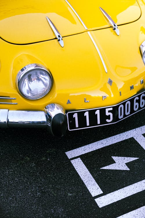 Yellow Vintage Car on a Street 
