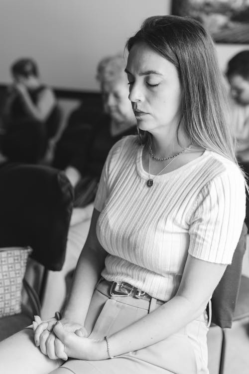 Woman Sitting with Eyes Closed at Gathering