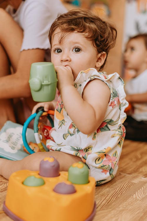 Baby Girl Sitting with Toys