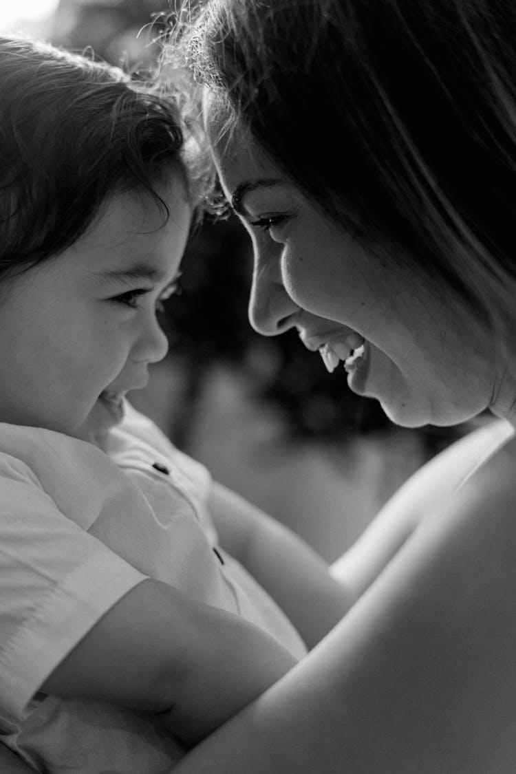 Mother Holding A Baby And Smiling 