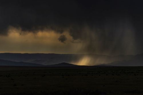 Free Dramatic overcast skies and rain over dark rural landscape in Wagon Mound, NM. Stock Photo