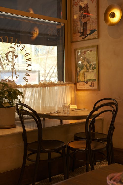 A Table by the Window in a Restaurant with a Vintage Interior Design 