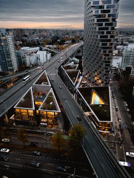A breathtaking aerial view of Vancouver's urban landscape featuring modern architecture and bustling highways at sunset.