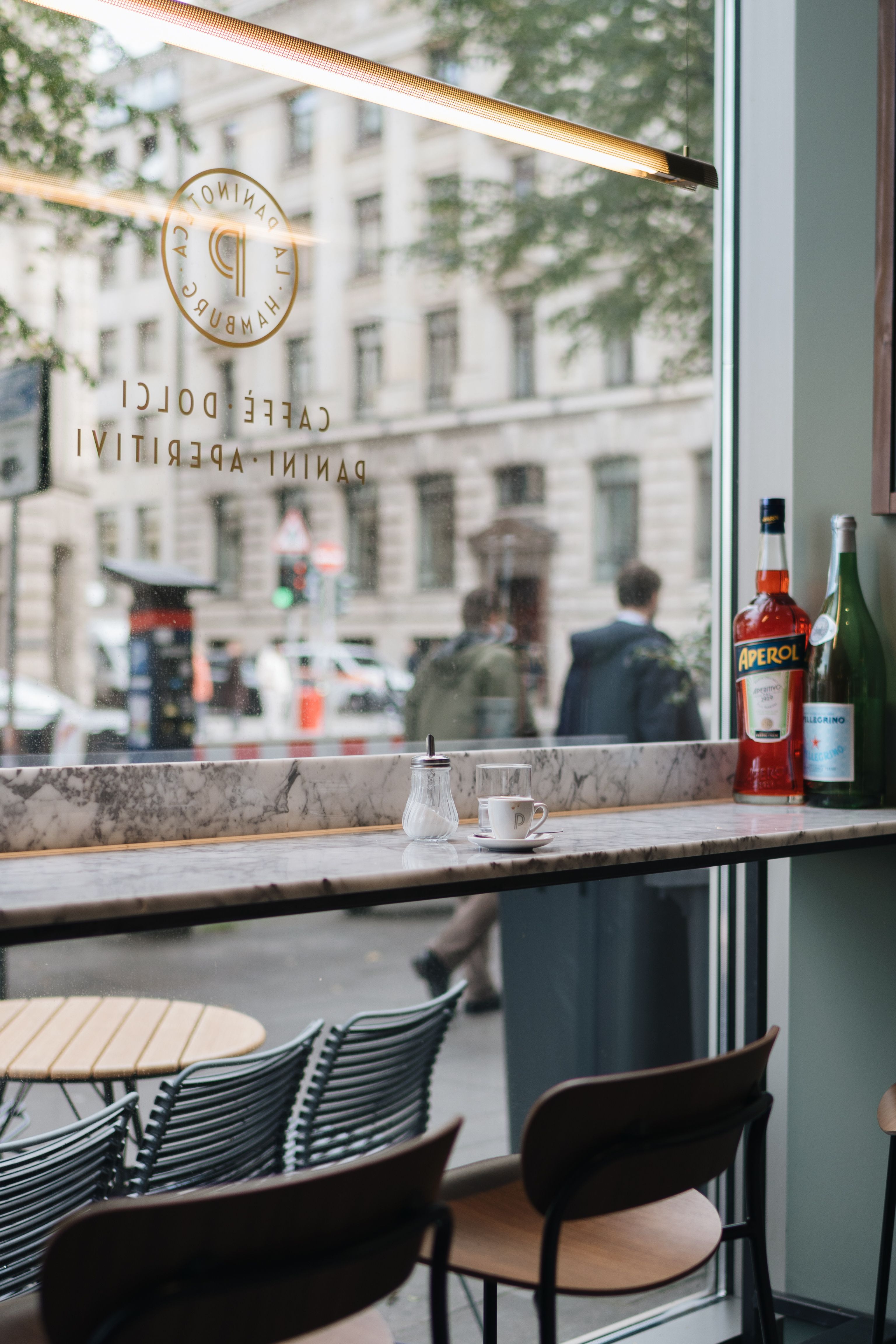 Cozy café in Hamburg with interior design elements and street view, depicting urban lifestyle.