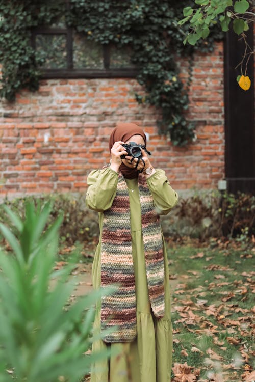 Woman Wearing Coat, Scarf and Photographing