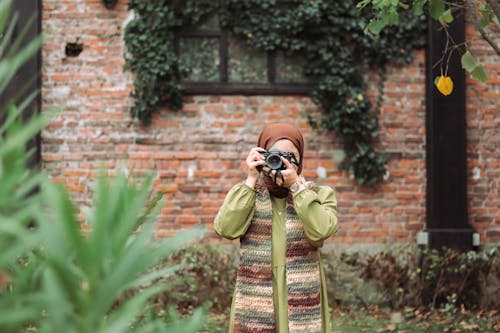 Woman Wearing Coat, Scarf and Photographing
