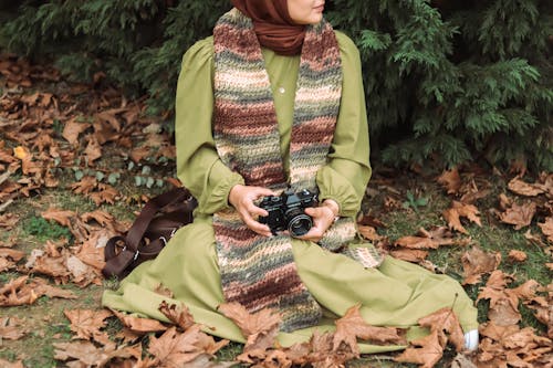 Woman Wearing Colorful Scarf and Holding Camera 