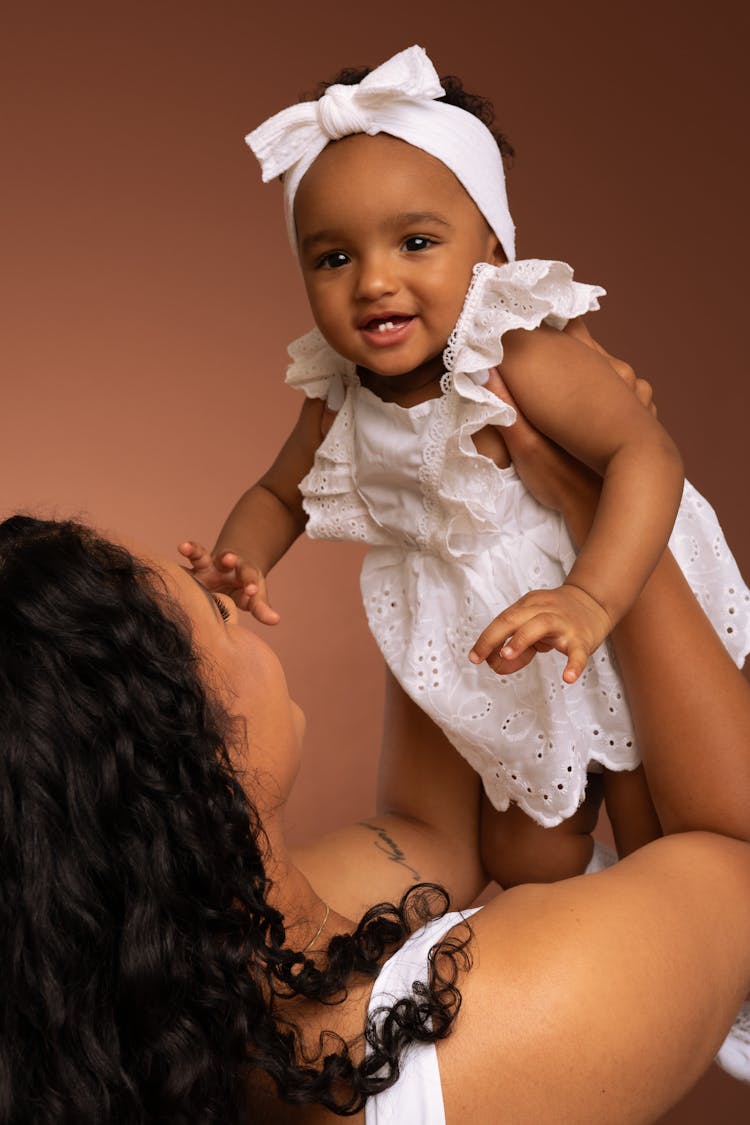 A Woman Holding A Baby Girl