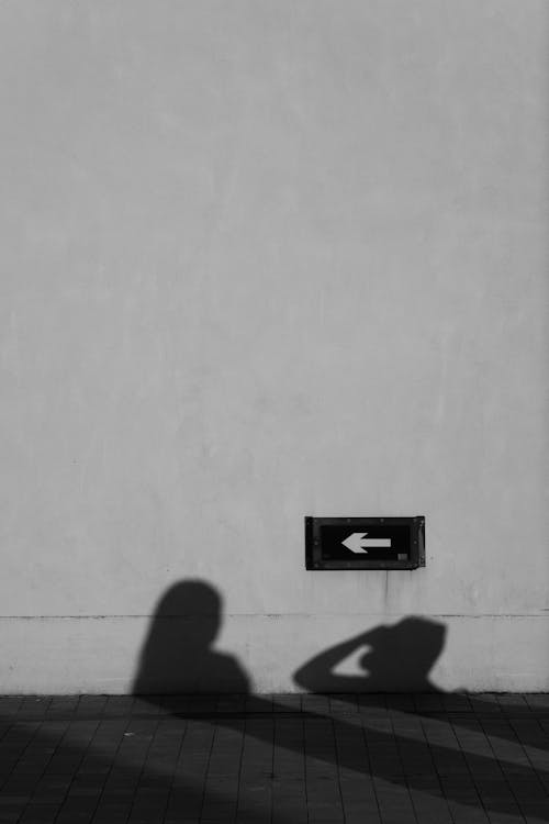 Shadow of People on a Wall and Pavement 