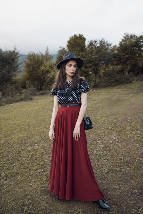 Woman in Red Skirt, Spotted Shirt and Fedora Hat