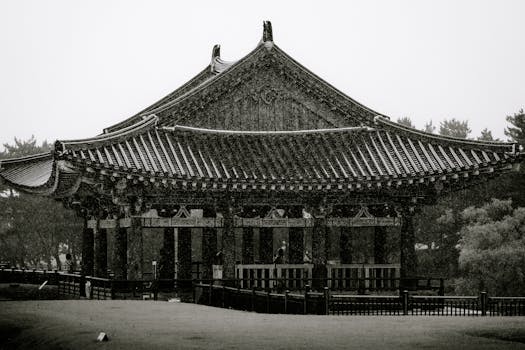 Breathtaking black and white photo of a historic Korean pavilion enveloped in rain, Gyeongju.