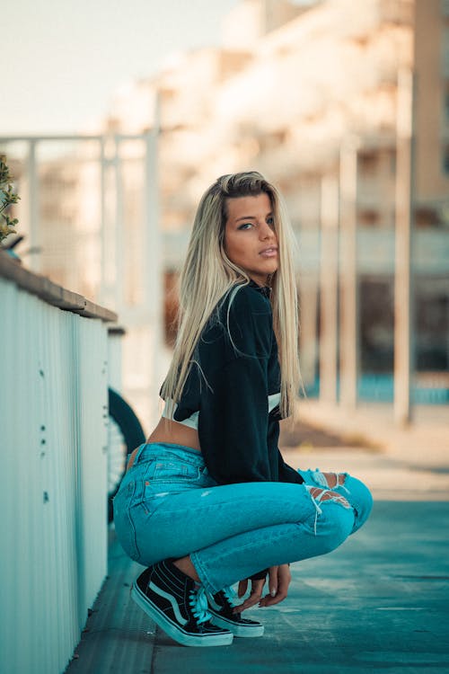 Model in a Black Crop Top and Distress Jeans on a Sidewalk