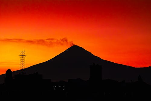 Silhouetted Mountain against a Bright Red and Yellow Sky 