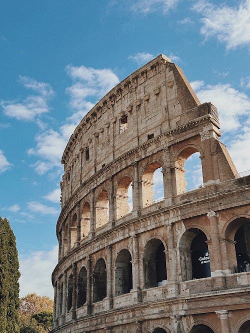 Colosseum under Fluffy White Clouds