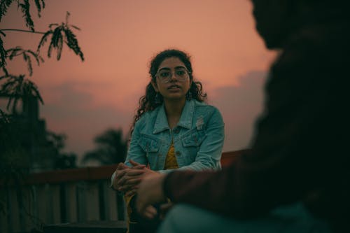 Young Brunette Woman in Denim Jacket at Dusk