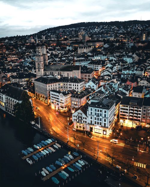 Free Stunning aerial view of Zürich, Switzerland, showcasing illuminated streets and iconic landmarks at twilight. Stock Photo