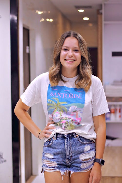 Teenage Girl in a Printed T-shirt and Denim Shorts