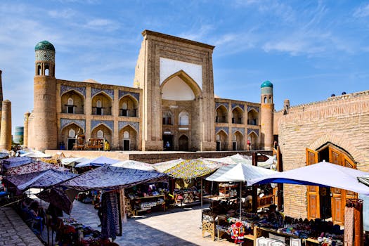 A bustling market scene in Khiva, showcasing stunning Central Asian architecture under a clear blue sky.