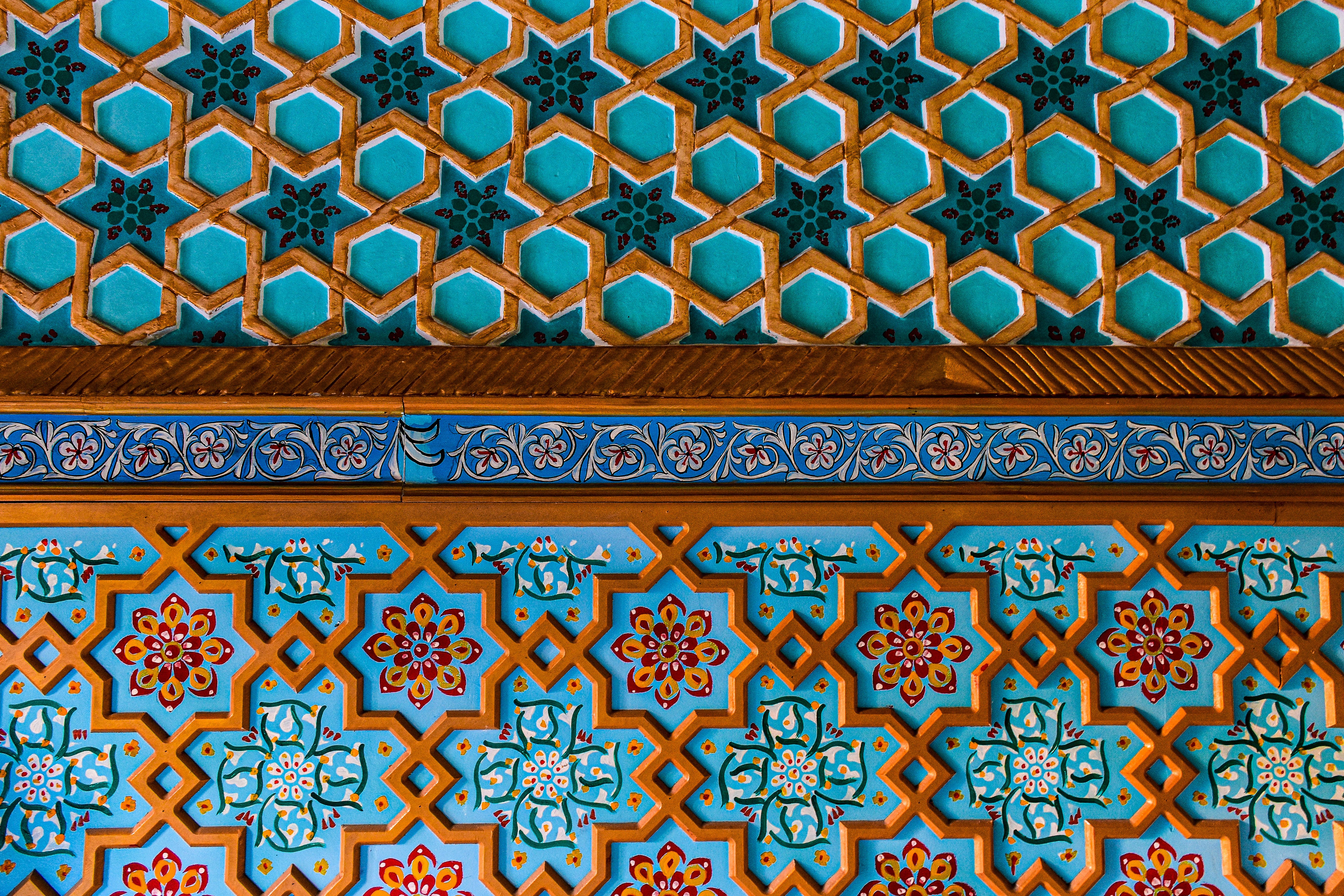Close-up of mosaic tiles on a wall with intricate patterns