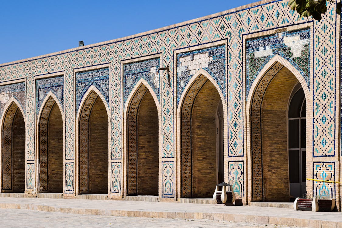 Free Decorated with Mosaic Tiles Arches in the Courtyard of the Poi Kalan Mosque in Bukhara Uzbekistan Stock Photo