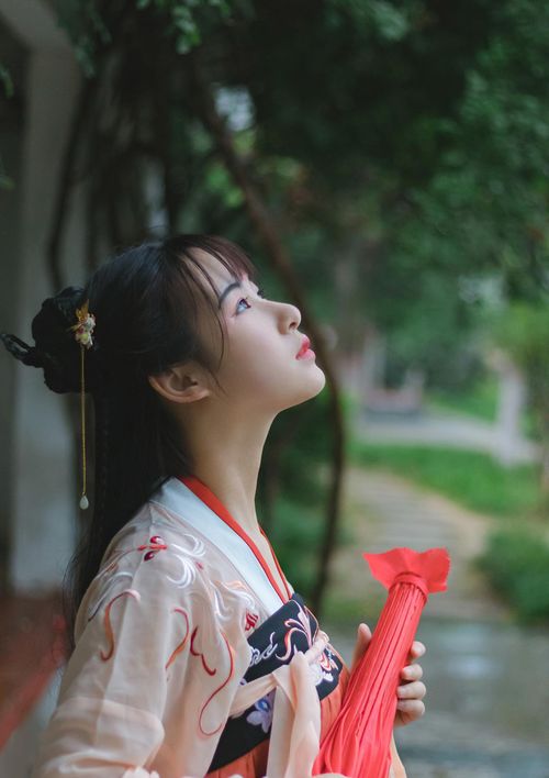 Free Graceful portrait of a woman in traditional clothing looking upwards in a serene setting. Stock Photo