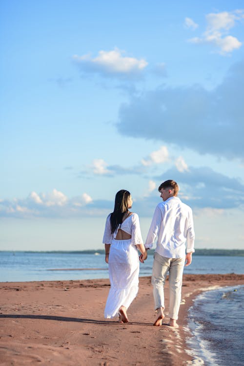 Couple Walking on a Sunny Beach