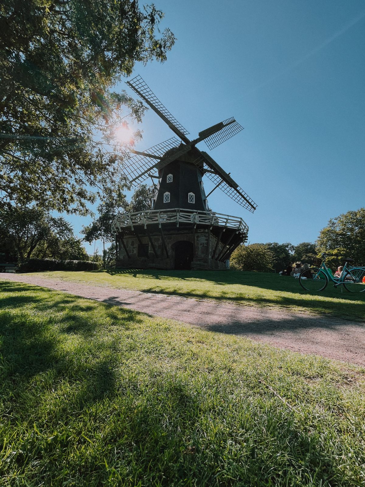 Traditional windmill in Kungsparken Malmö surrounded by lush green park — a reminder of Skåne's flat, agricultural landscape and rural heritage