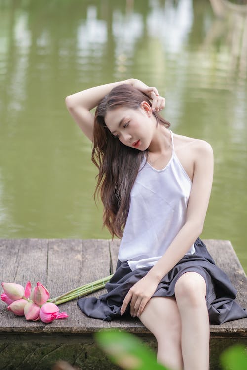 Model in Blouse and Skirt Posing by Lake