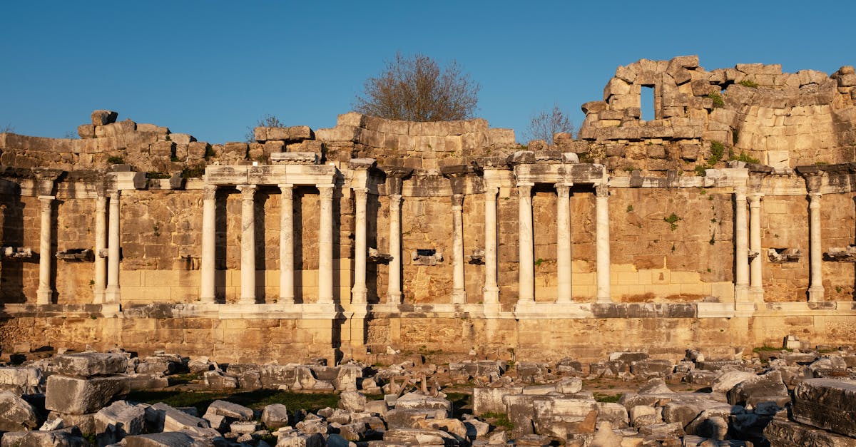 Explore the majestic ancient Roman ruins in Side, Antalya, Türkiye, bathed in golden sunset light.