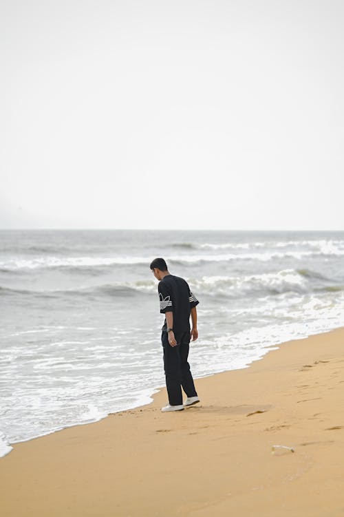 Man Standing on Sea Shore
