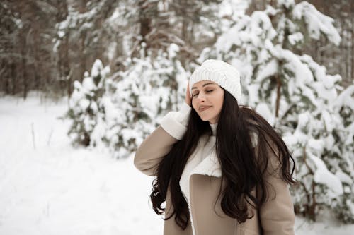 Young Woman Standing in the Forest in Winter 