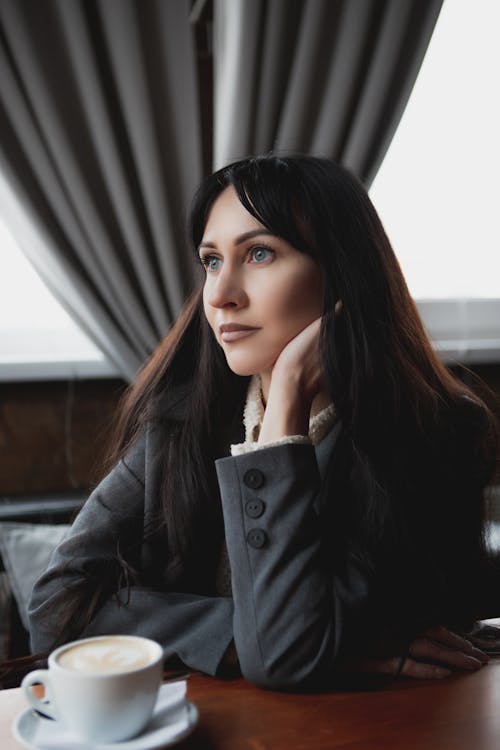 Portrait of Woman Sitting by Table