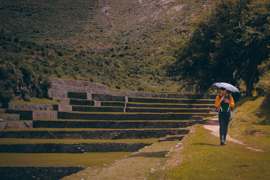 Traveler using Google Maps on a smartphone in the historic center of Cusco, Peru