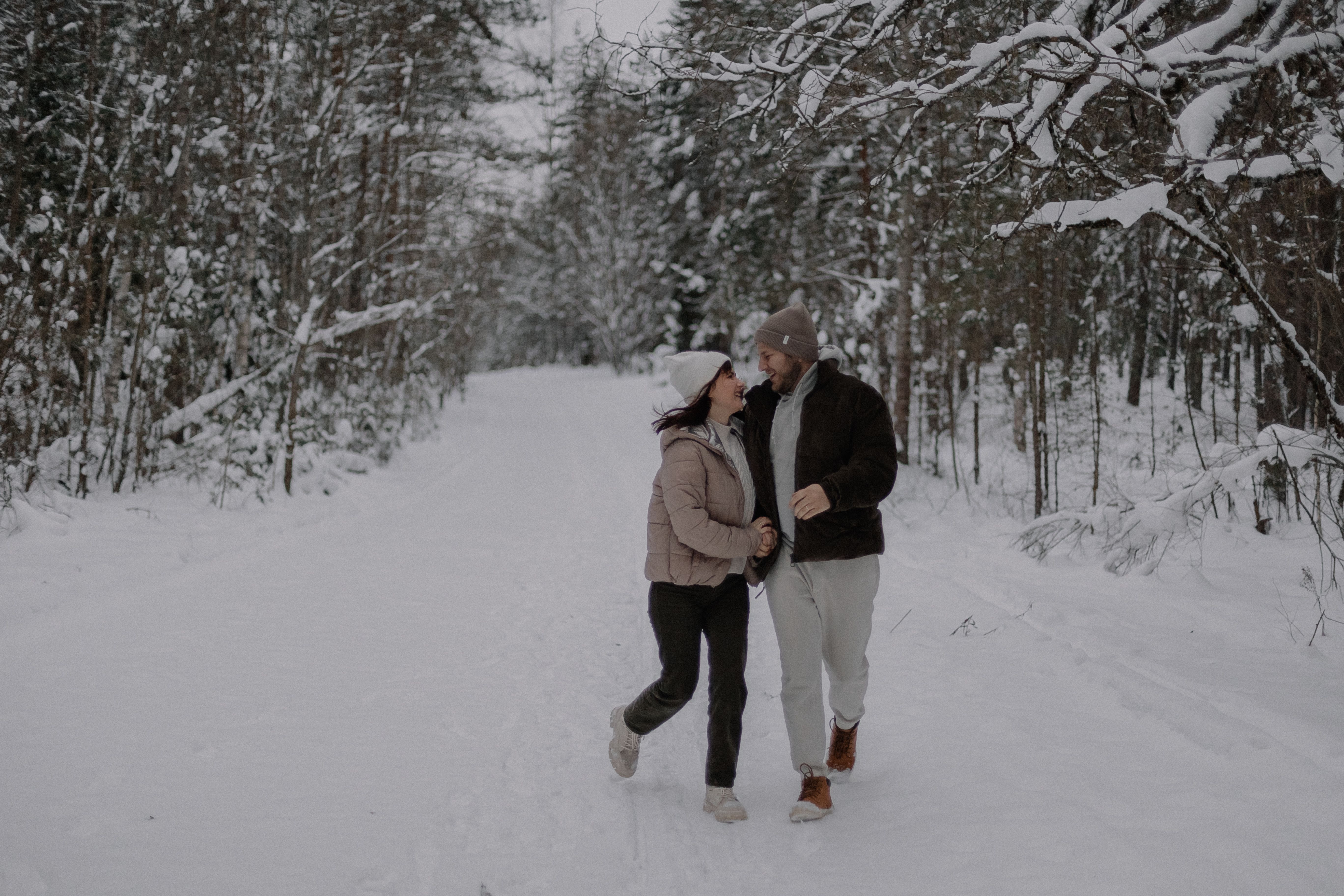 Smiling Couple Walking Together in Forest in Winter · Free Stock Photo