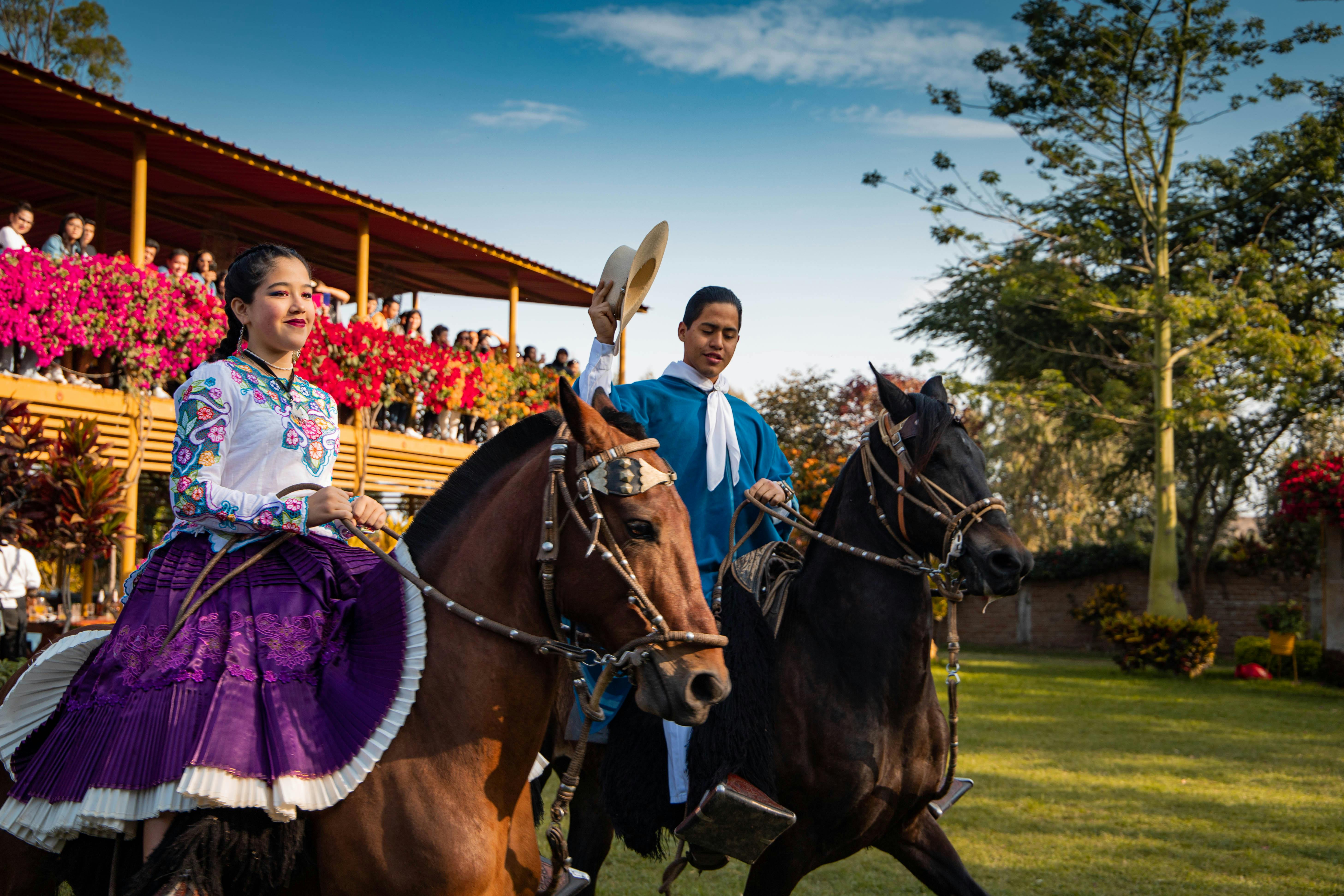A vibrant traditional Peruvian ceremony featuring riders in cultural attire on horses, captured in Jayanca.