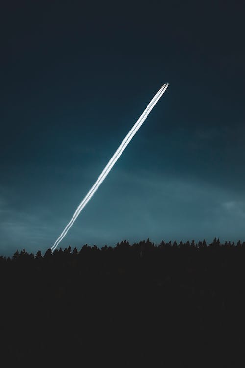 A jet plane flying through the night sky