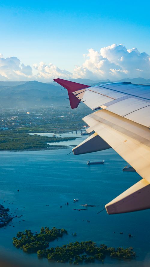 Free Breathtaking aerial view of the Manila skyline and sea from an airplane window. Stock Photo
