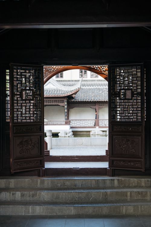 Free View of intricate Chinese architectural design through an open gate. Stock Photo